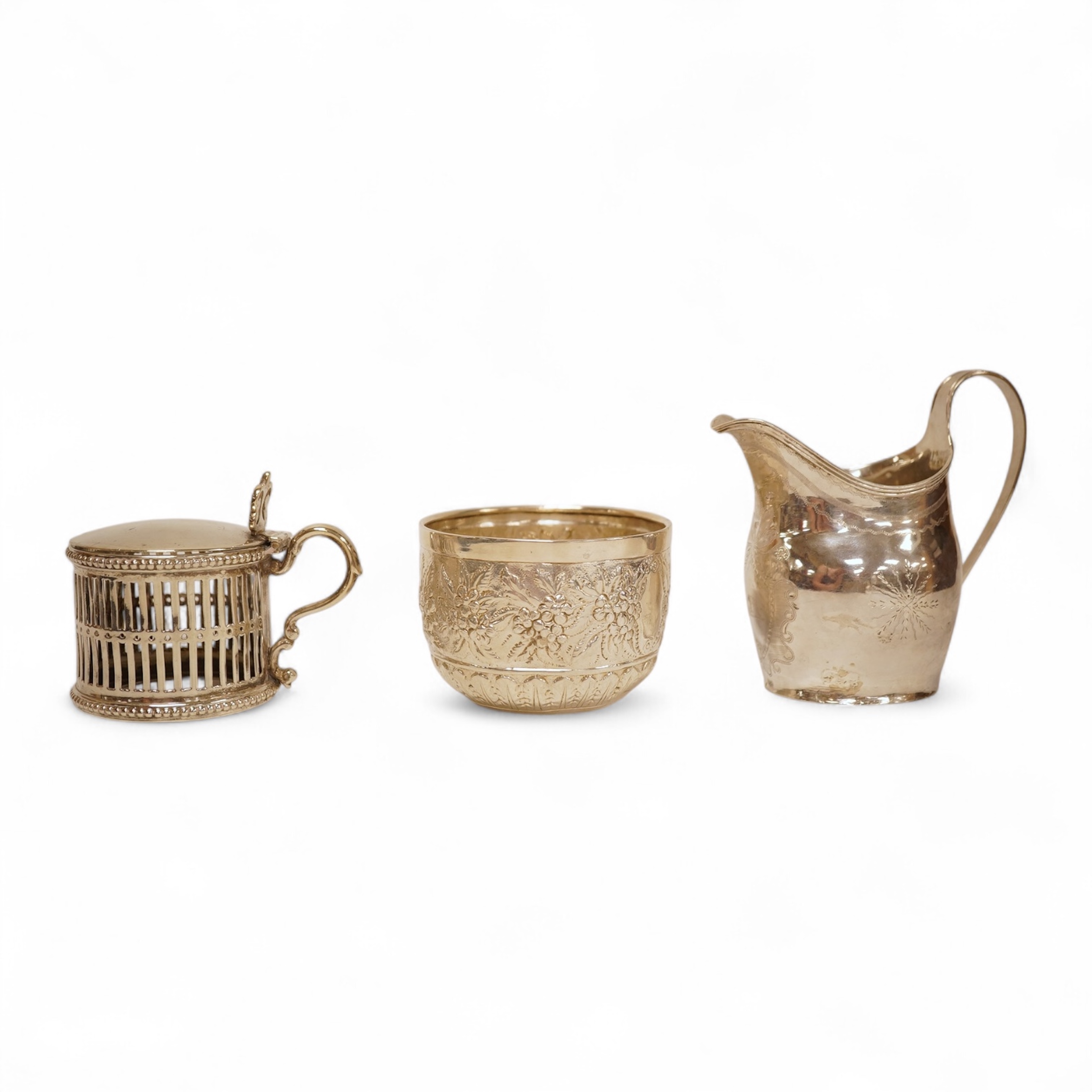 A George III silver helmet shaped cream jug, marks rubbed, 10cm(a.f.), together with a later Victorian silver sugar bowl and similar pierced silver mustard pot, no liner.